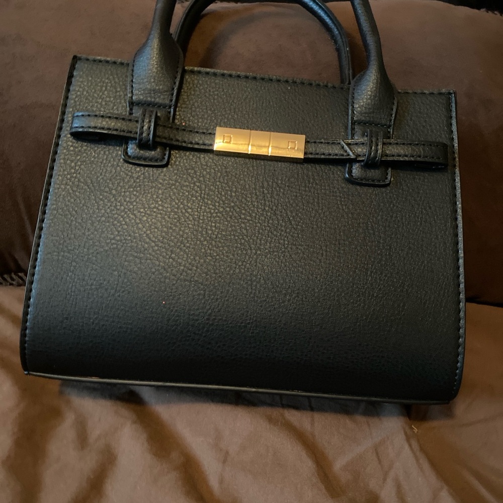 Cute black purse that I believe is a Birkin imitation.  Light weight.